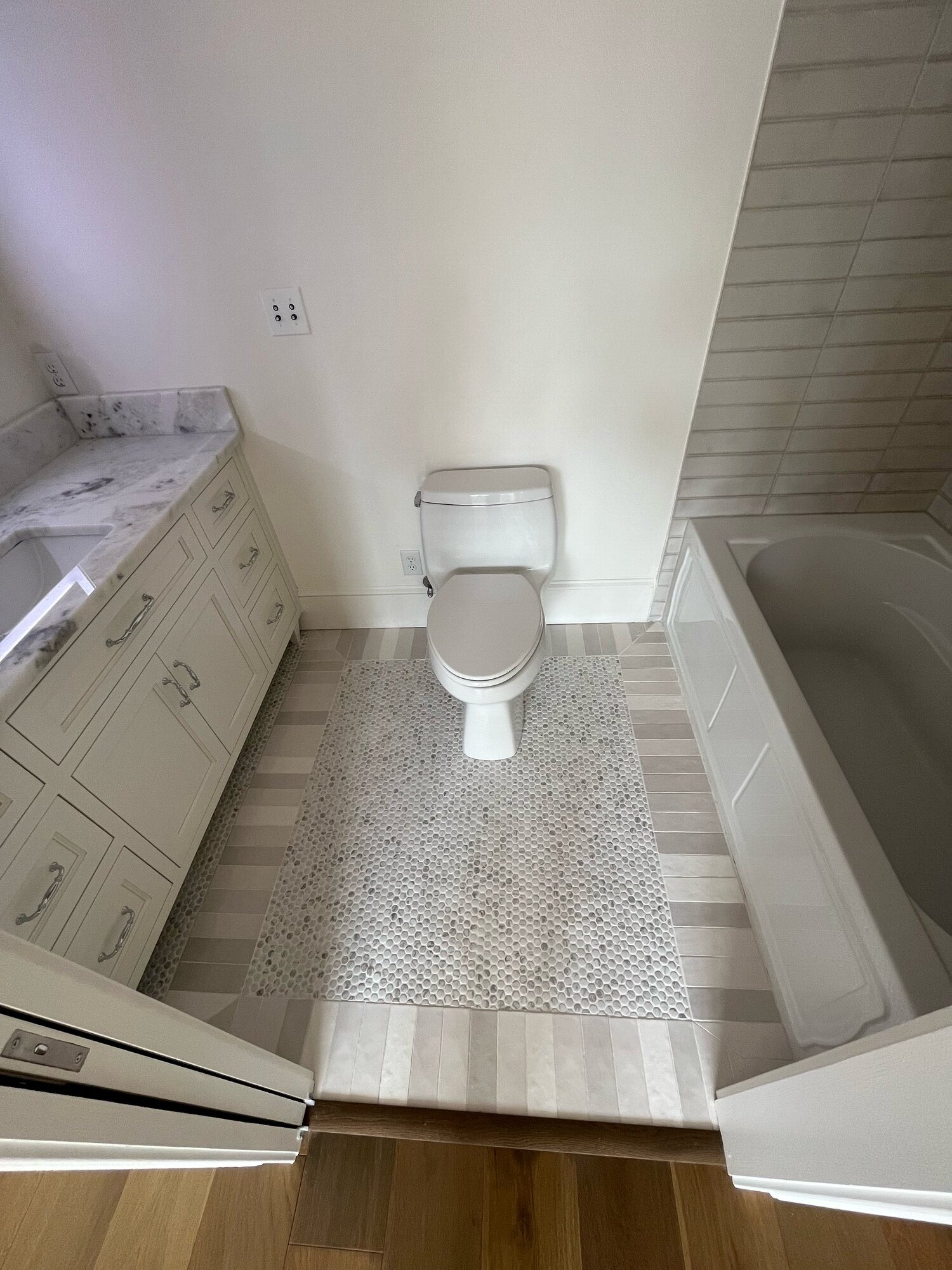 Bathroom with penny-tile accent wall and custom vanity
