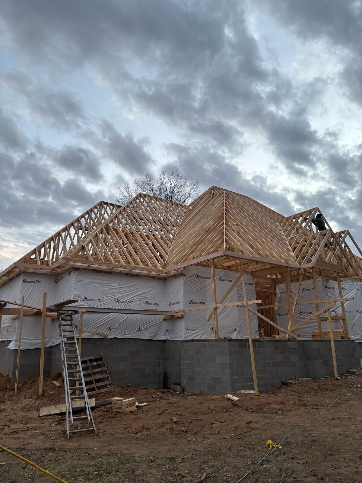 Custom home roof framing with trusses in progress